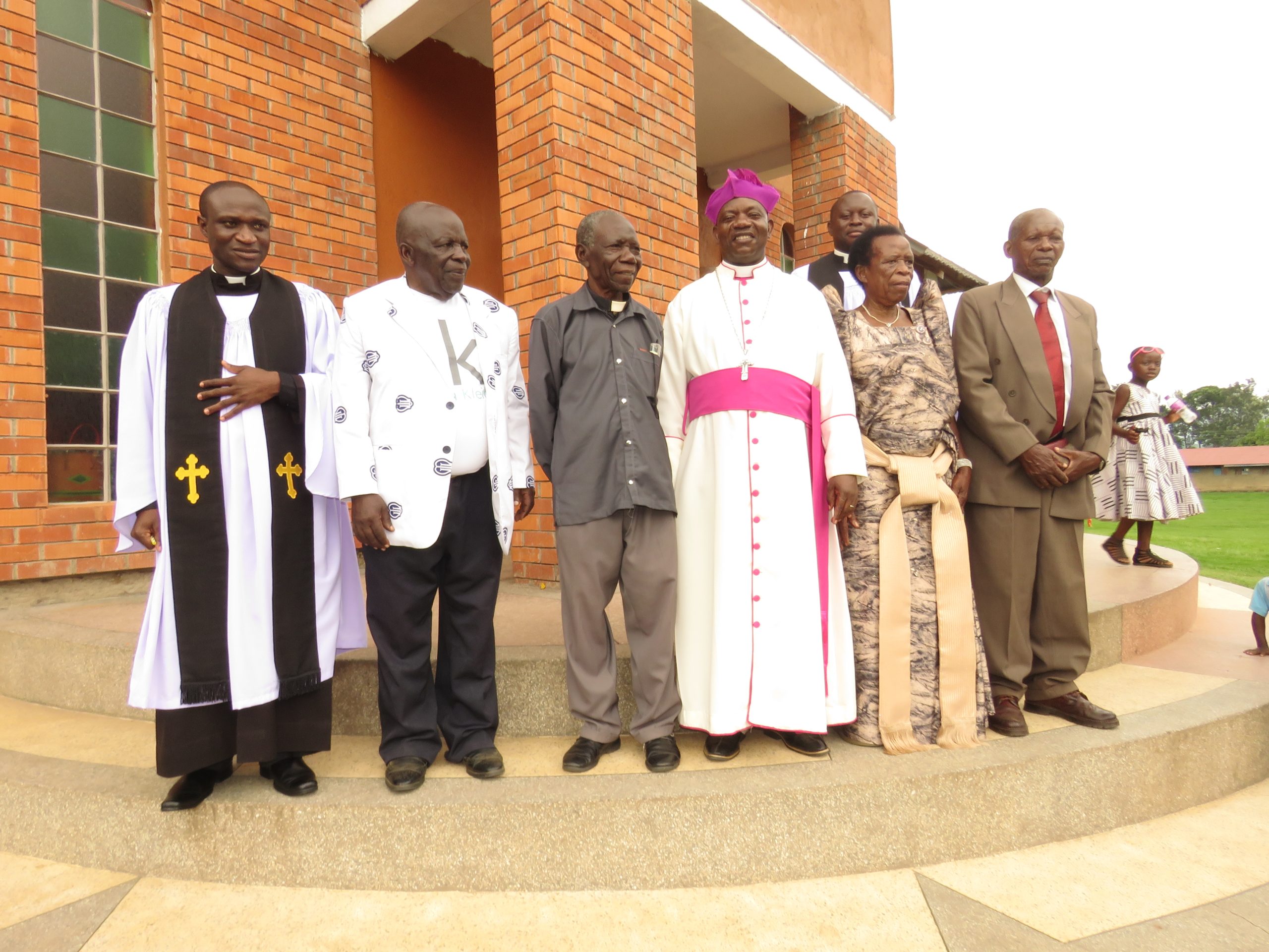 The Bishop Standing outside the cathedral with church elders and Reverend of the Diocece